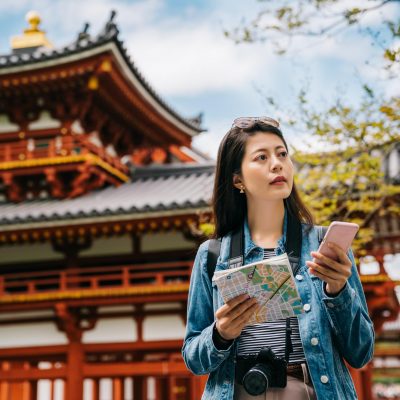 asian-tourist-using-smartphone-map-search-sightseeing-spot-byodo-temple-background-with-blue-sky-travel-lens-man-chatting-by-mobile-phone-communication-app-travel_678158-7475